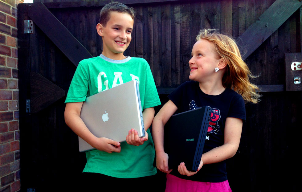 brother and sister with laptops